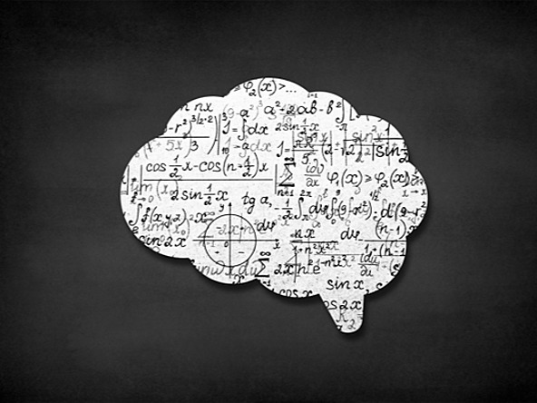 black and white image of a cut out shape resembling the human brain with mathematical symbols written on top  